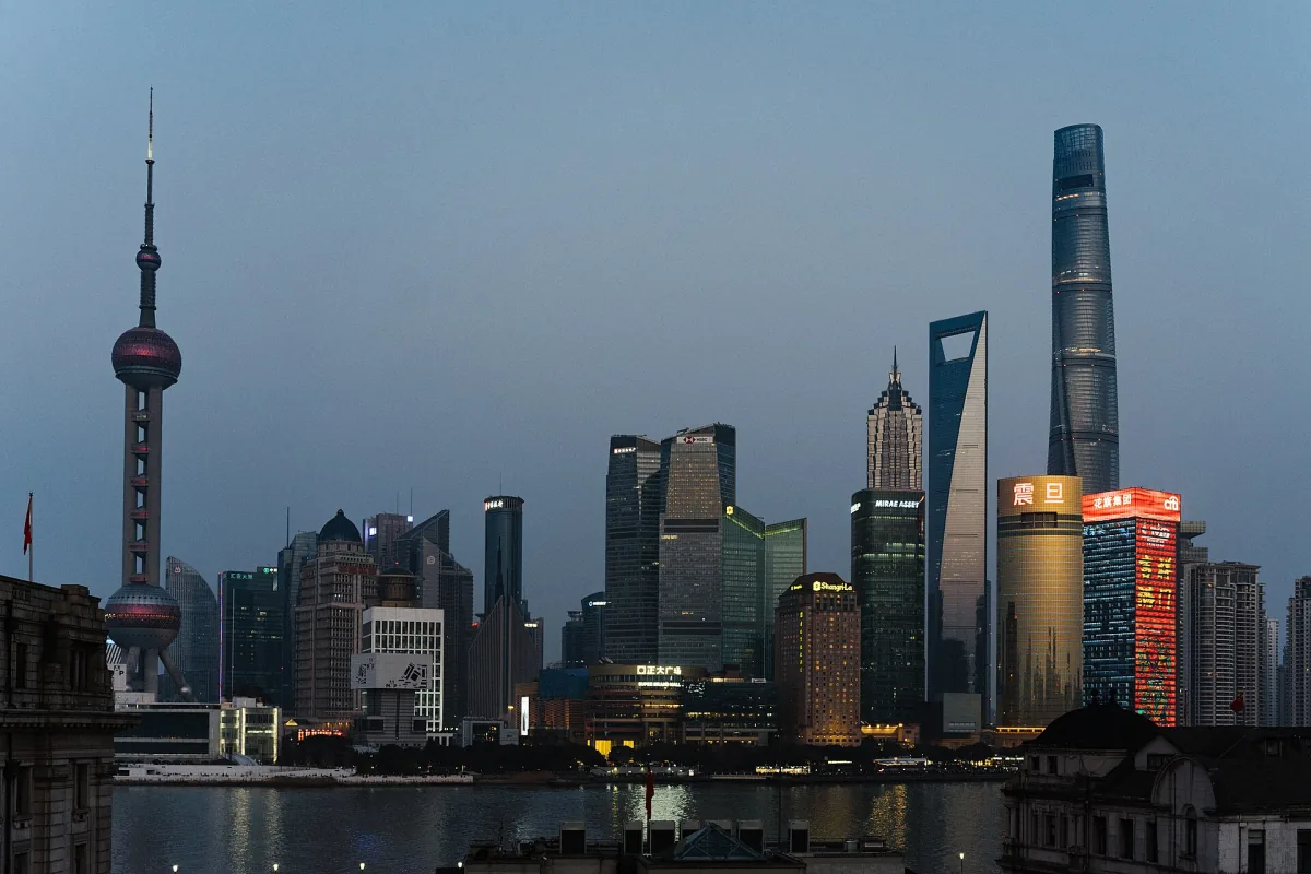 Shanghai's illuminated Pudong skyline across the Huangpu River at dusk